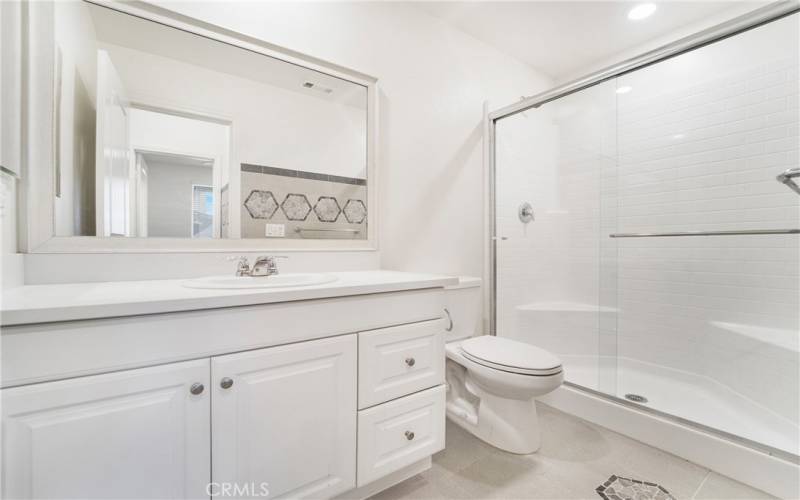 Downstairs bathroom offers lots of designer touches. Enjoy upgraded tile work and countertops.