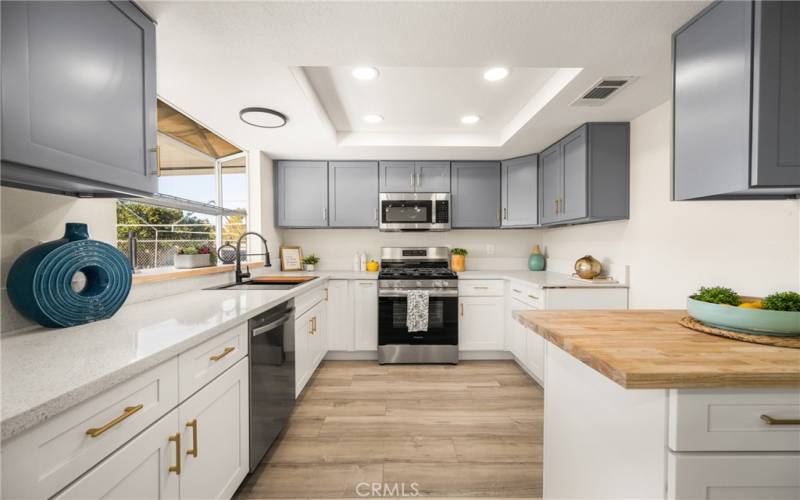 Gorgeous 2 Tone Kitchen with brushed Gold hardware, stainless appliances and, soft close drawers