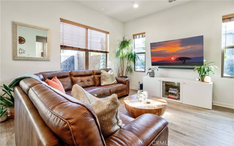 Living room with windows to both front area & back private patio