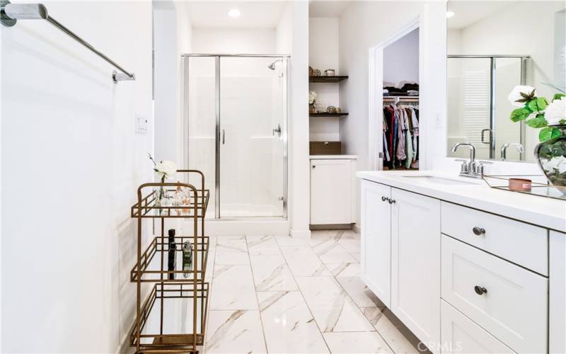 Primary bath with private toilet area - looking towards shower, cabinetry & walk in closet.  Notice how open & large this bathroom is!