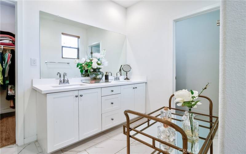 Primary bath with dual sinks, large vanity.  Open & bright space