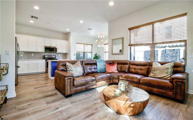 Spacious living room flows to both kitchen & dining areas.  Such an open & bright space