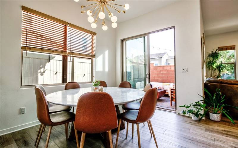 Dining room with lots of windows leads to private, cozy patio