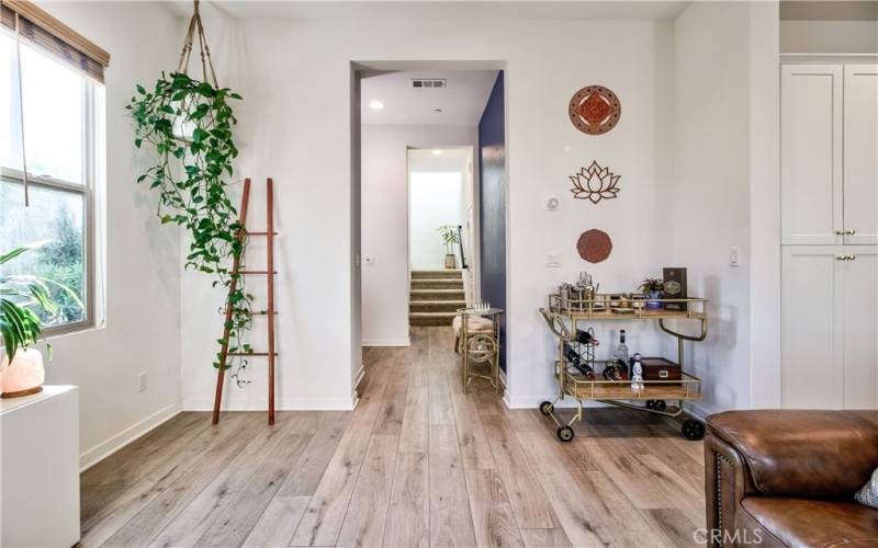 Living room looking towards stairs.  Powder room off to the left, garage to the right just before the stairs