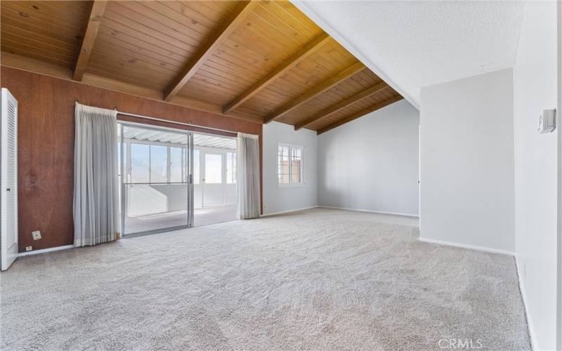 Living room with wood vaulted ceilings.  New carpet and paint.