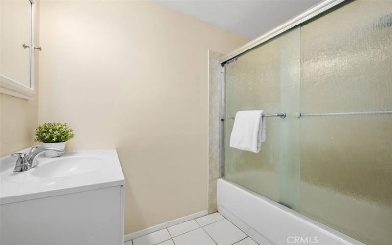 Upgraded with rain glass shower/tub doors.