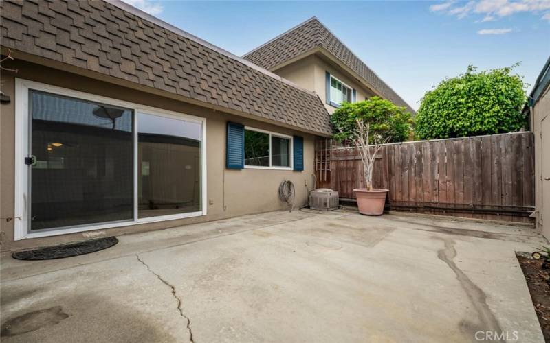 Large patio for outdoor living or play yard.