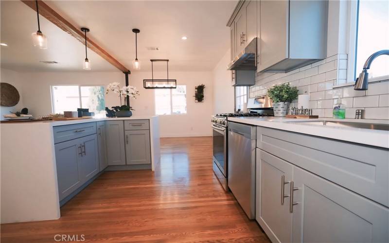 Remodeled kitchen with white quartz countertops