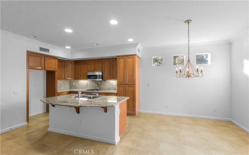 Kitchen is adjacent to dining area and features floor to ceiling wall pantry