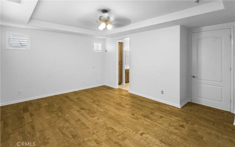 Primary bedroom has beautiful wood floors