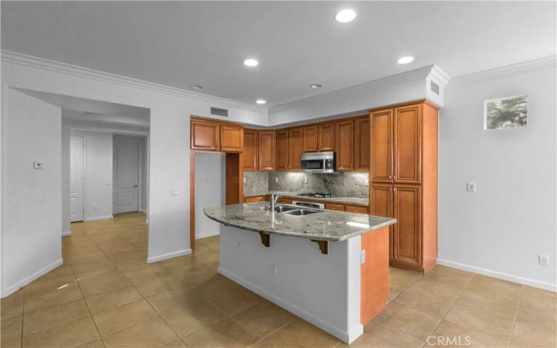 Beautiful warm kitchen cabinetry and solid surface granite counter tops