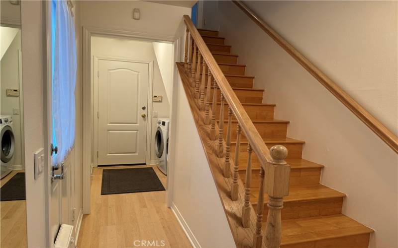 Laundry behind stairs on first floor.