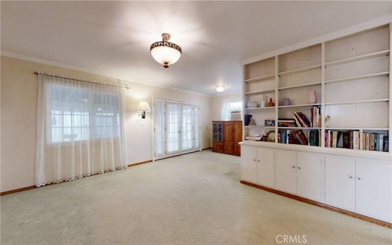 Living room with built in book cases and cabinets