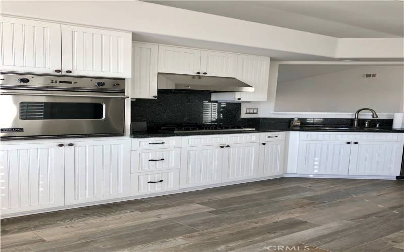 Beautiful kitchen with all brand new flooring throughout the home, viking oven , stainless steel refrigerator, dishwasher and microwave! All with ocean views!