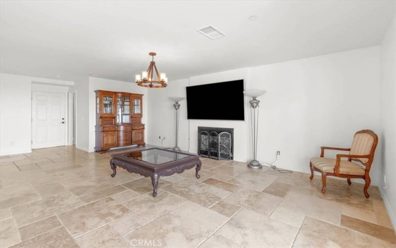 Downstairs entertaining room with TV, and fireplace.