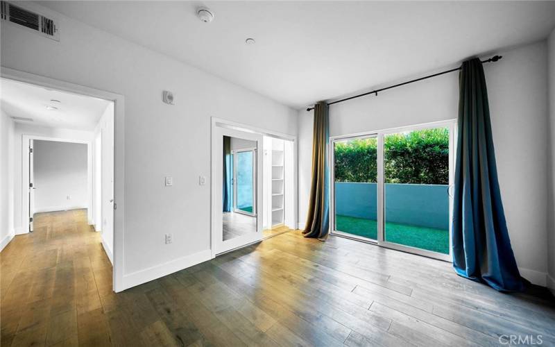 Bedroom with sliding glass door to private patio.  Mirror closet doors.