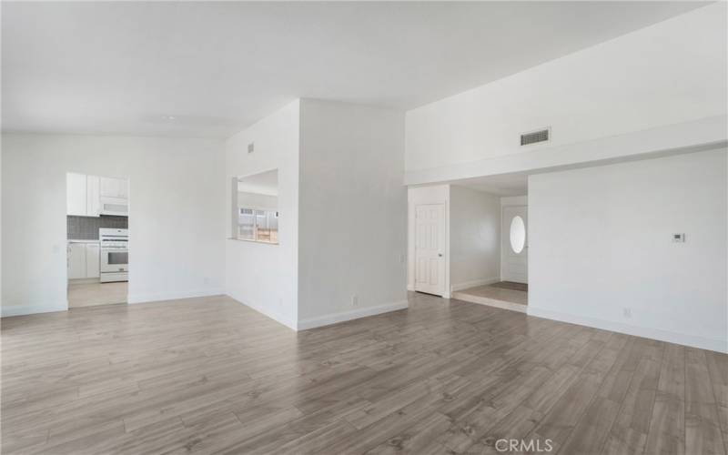 Living room, dining room, foyer and kitchen in this photo