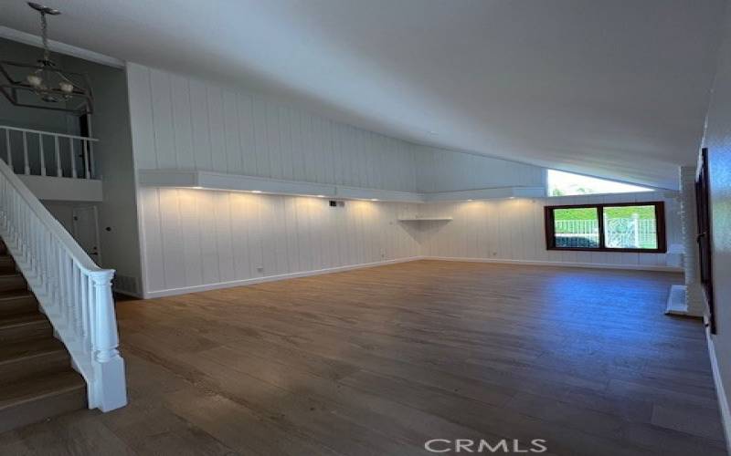 Living room with vaulted ceiling and wood burning fireplace