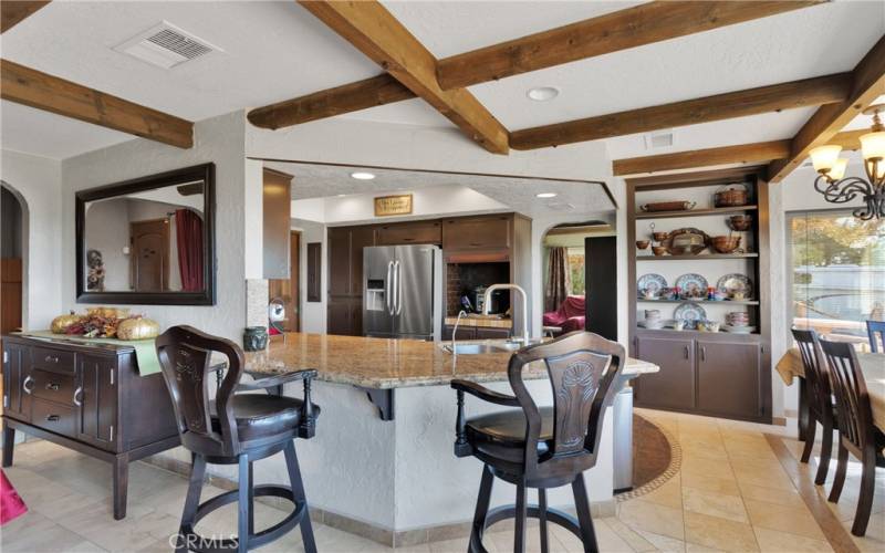 Rustic elegance with beam ceilings, natural stone tile, granite counters and wrought iron elements throughout.