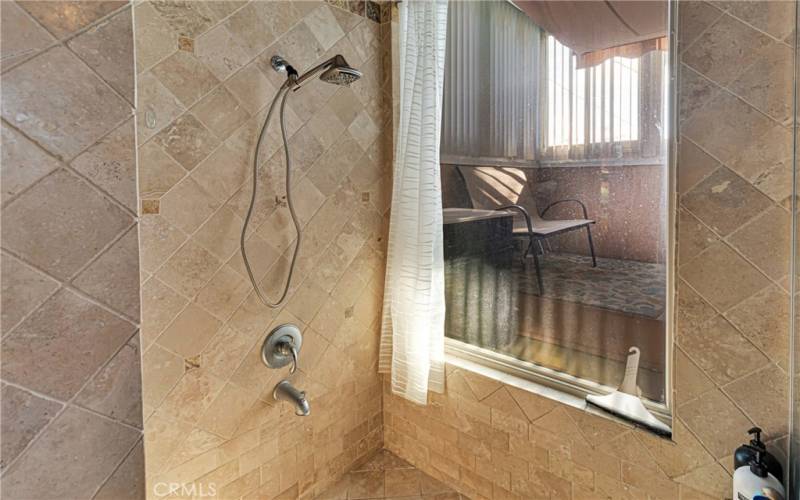 Roman tub and shower with natural stone. Adjacent to this is a spearate spa sanctuary room.