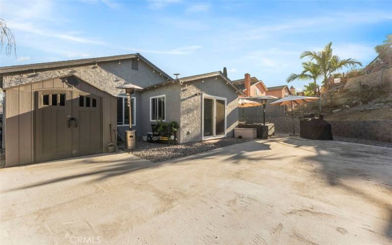 Backyard with plenty of space, and storage shed.