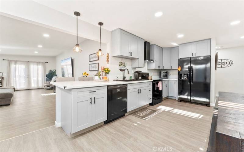 Updated kitchen with black appliances, and quartz countertops.