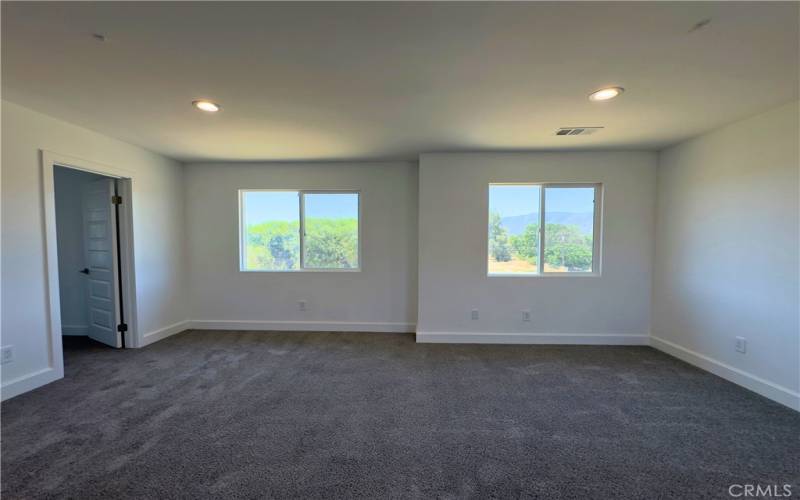 Spacious master bedroom with partial view of the lake.