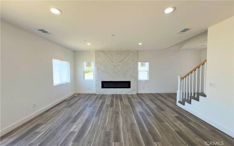 Super bright living room with built in fireplace.