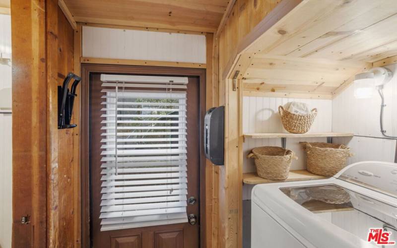 Laundry room with full size washer and dryer inside.