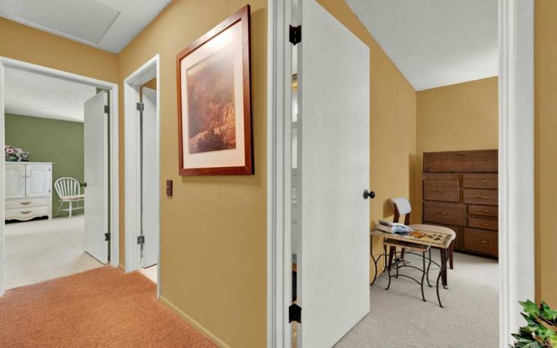 View of 2nd bedroom, hallway and primary bedroom from the entryway.