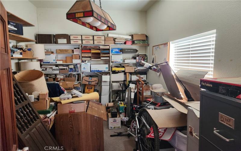 This room used as an office has been decluttered since this oic was taken.