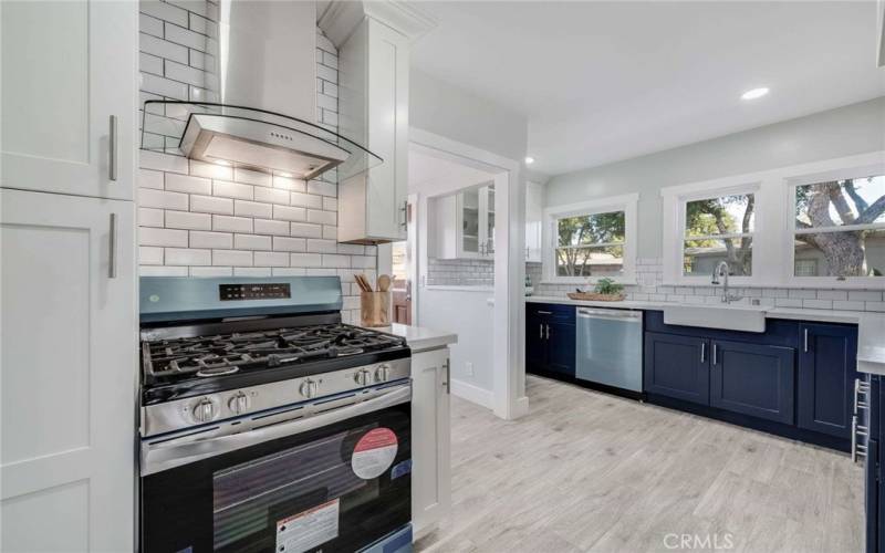 Beautifully remodeled Kitchen with Stainless Steel Appliances, Farm House Sink, New Cabinetry, Quartz countertops and Subway Tile backsplash.