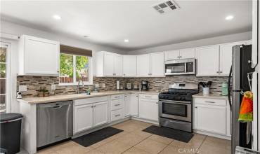 Kitchen with granite counter tops, tile backsplash and flooring.  Built-in microwave and a dishwasher for convenience.