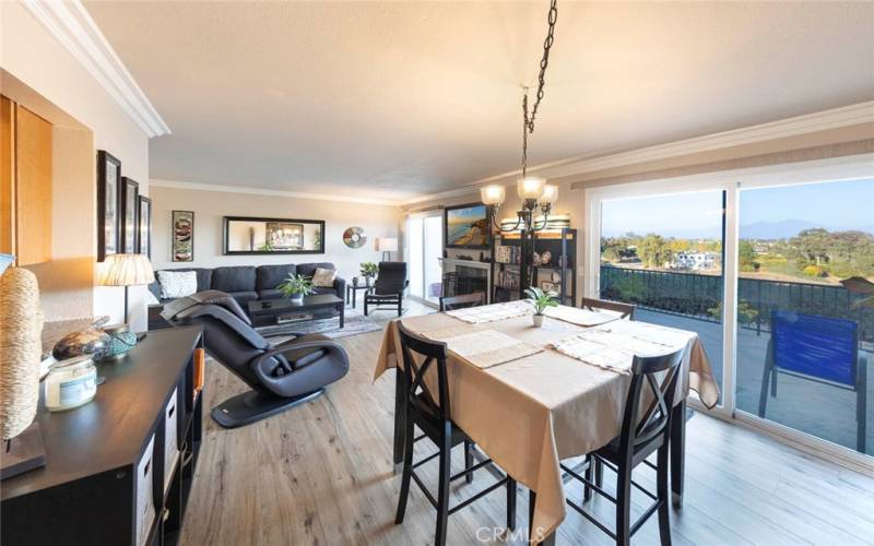 Dining and living space with sliding doors to oversized patio and sweeping views.