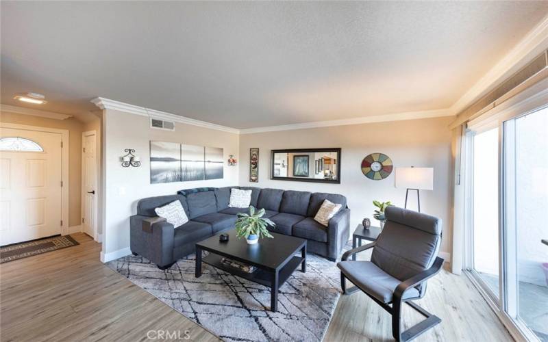 Living room that has sliding doors leading to back patio space.