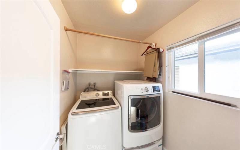 Upstairs laundry with storage.