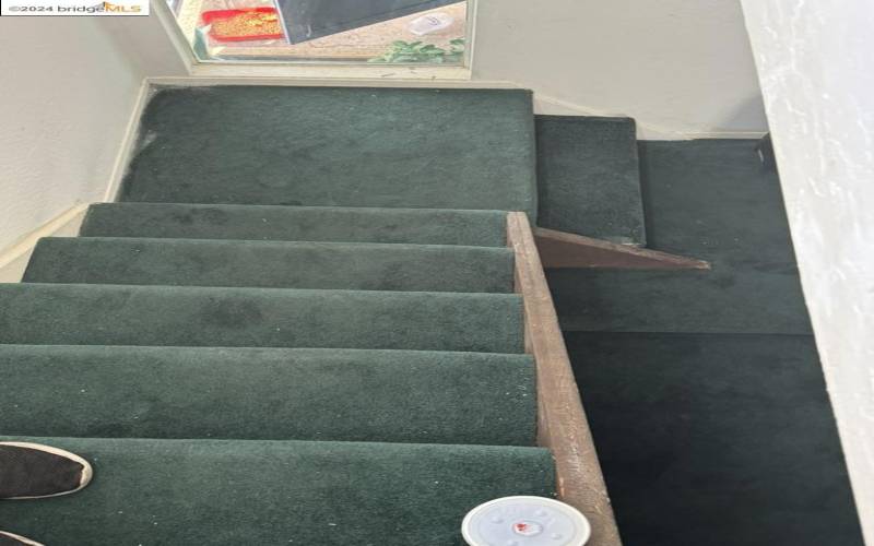 Stair case from master back down into family room