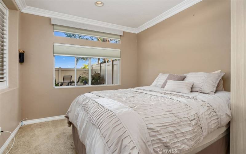 Downstairs bedroom overlooks rear yard area garden