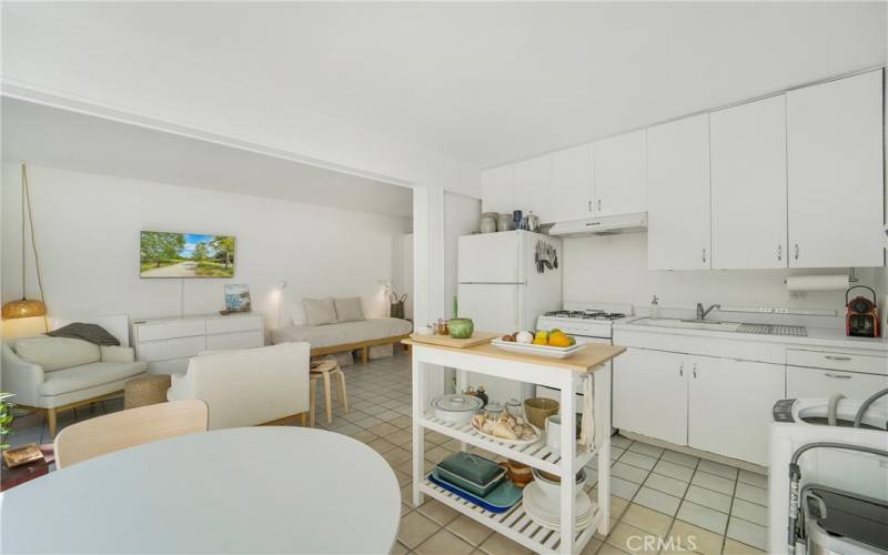 View into living area from kitchen and eating area.