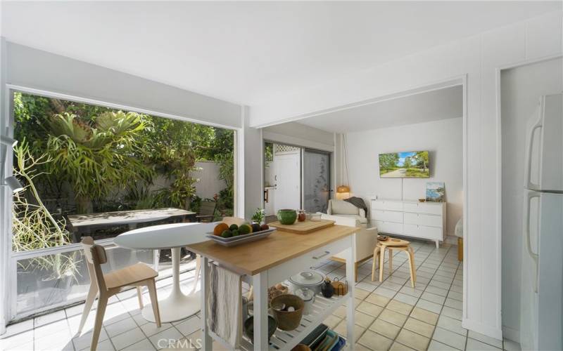 View into beautifully landscaped patio from kitchen area.