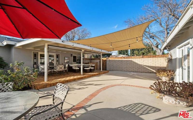 Additional seating area with table and chairs with umbrella