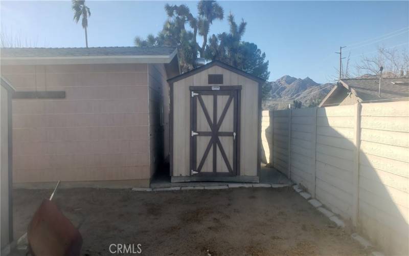 GARAGE WITH A SECOND STORAGE SHED.