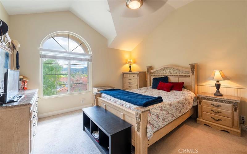 Large Primary Bedroom features Palladian window, high ceiling & wainscoting