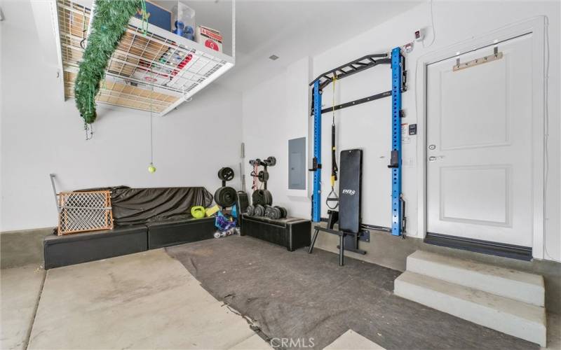 Garage area with PRX wall mounted gym.