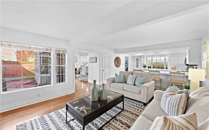 Another view of the family room, with the kitchen beyond and the front entry.