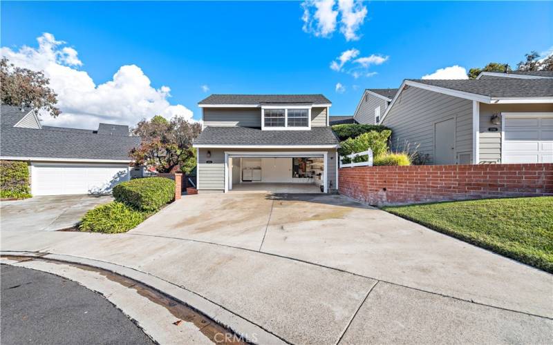 A view of the driveway, garage and the front of the home.