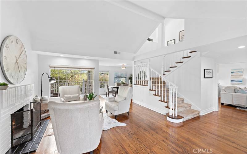 A view of the living room, dining room beyond and the staircase leading up to the 2nd level.