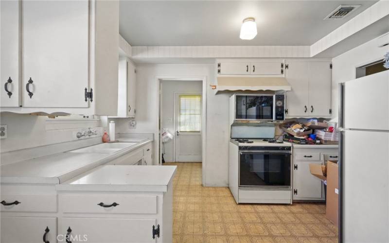 door towards the back leads to 1/2 bathroom, laundry room & access to back yard