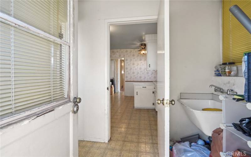 Laundry room next to kitchen