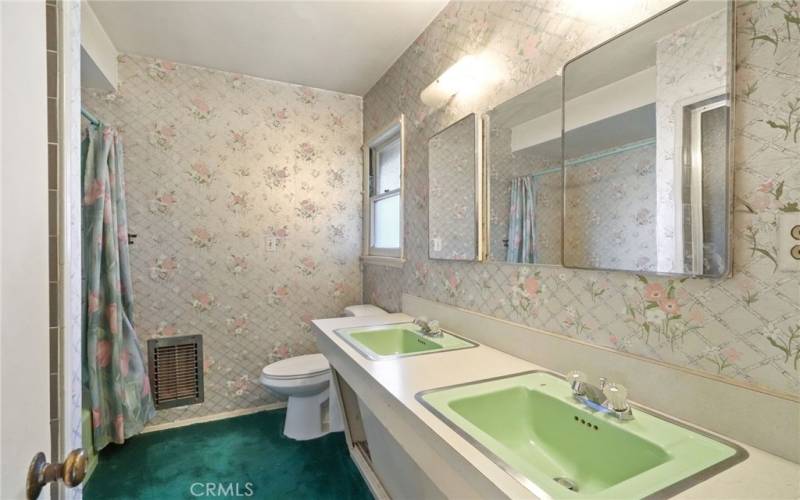 Large full bathroom with tub and double sinks